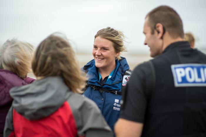 A photo of a Wildlife Warden talking to people about wildlife