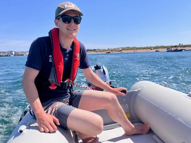 A photo of Wildlife Warden Caius on our inflatable tender 