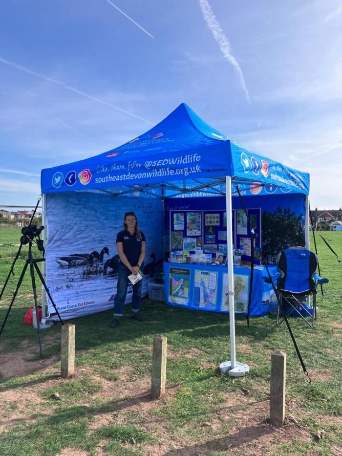 Wildlife Warden Imo standing in the South East Devon Wildlife gazebo