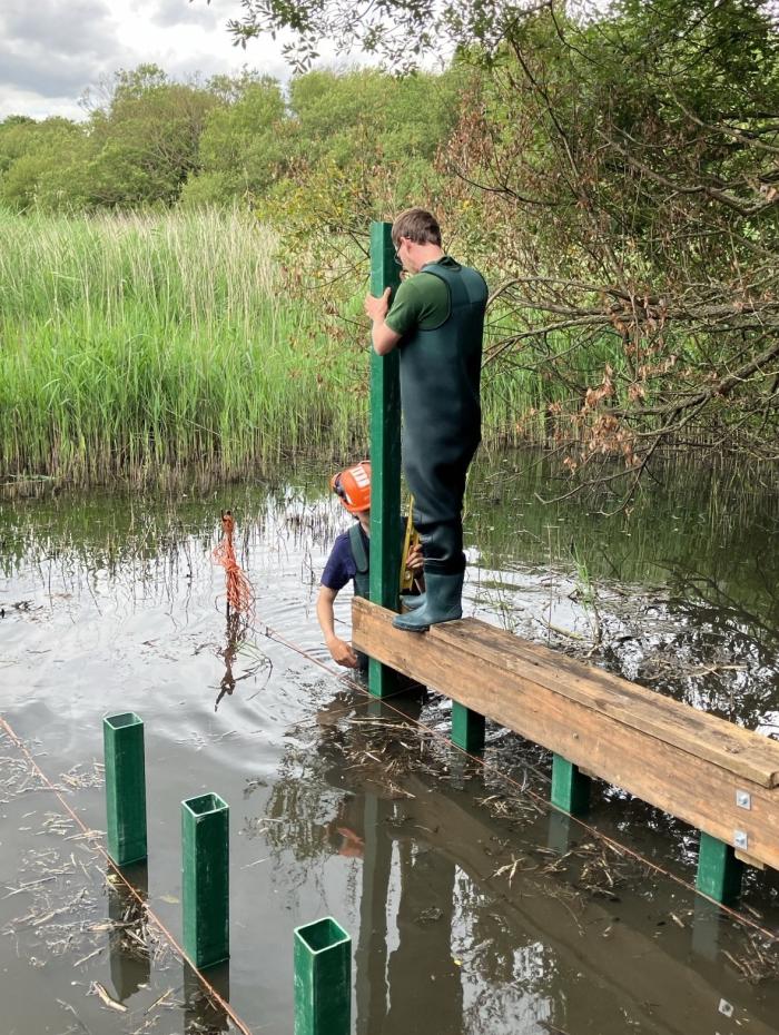 A photo of Caius making the pond dipping platform