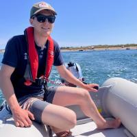 A photo of Wildlife Warden Caius on our inflatable tender 