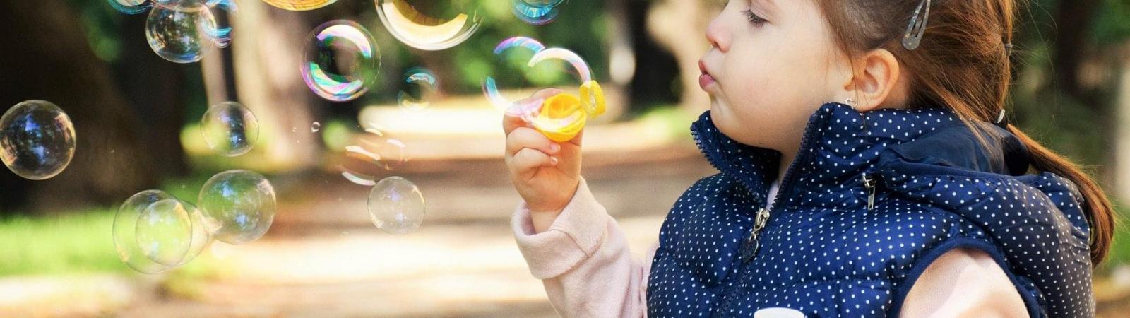 Female child blowing bubbles